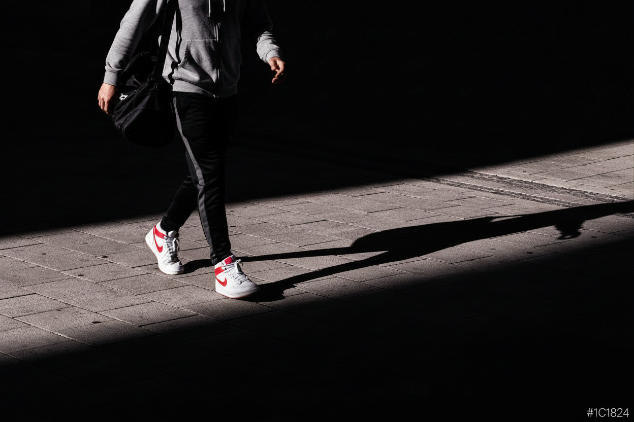 Determined young football athlete walking onto the pitch